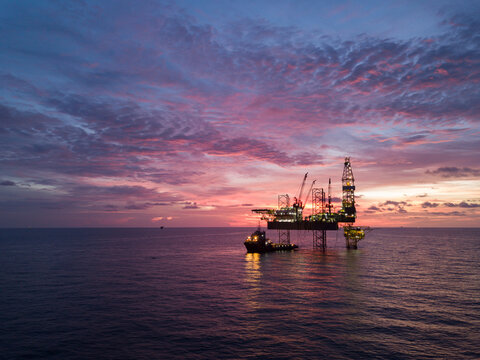 Aerial view offshore drilling rig (jack up rig) at the offshore location during sunset