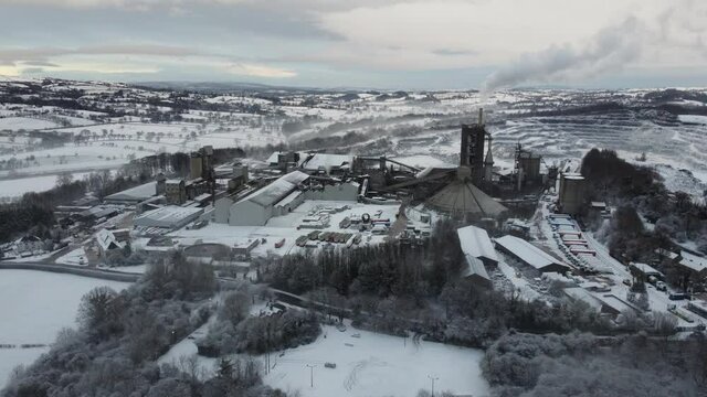 Large limestone quarry and cement factory in clitheroe, Lancashire. Ribble valley industrial landscape in snowy winter conditions