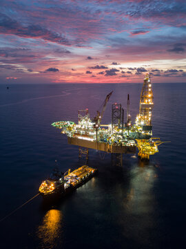 Aerial view offshore drilling rig (jack up rig) at the offshore location during sunset