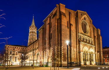 Fototapeta na wymiar The Basilica of Saint Sernin illuminated at night, in Toulouse in Occitanie, France