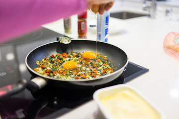 In the course of making breakfast with fresh eggs and vegetables