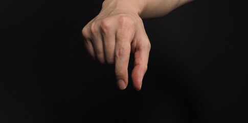 Man hand holding gestures and empty, isolated on black background.