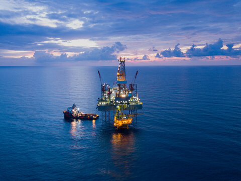 Aerial view offshore drilling rig (jack up rig) at the offshore location during sunset
