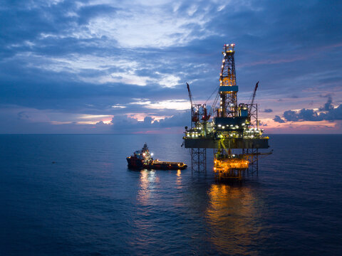 Aerial view offshore drilling rig (jack up rig) at the offshore location during sunset