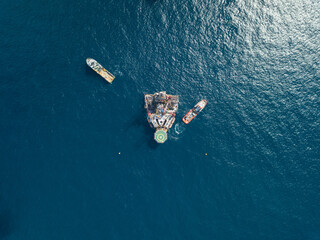 Offshore jack up rig and tow vessels during the rig move operation at the offshore location