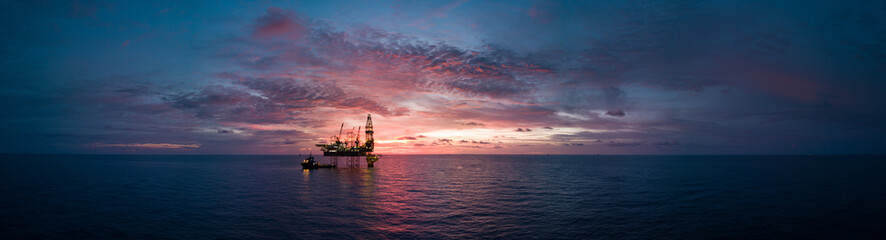 Aerial panorama view from a drone of an offshore jack up rig during sunset time at the offshore...