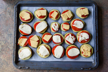 Eggplants with cheese and tomato.