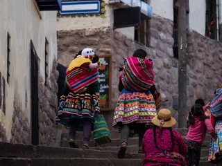 Foto op Canvas Indigenous quechua women in traditional colorful handwoven textile clothing dress costume walking in Cusco Peru © Marc
