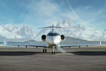 private jet airplane on the ground waiting to be boarded
snowy mountains in the background - obrazy, fototapety, plakaty
