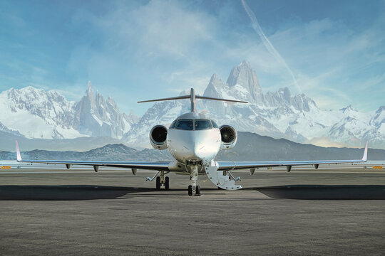 private jet airplane on the ground waiting to be boarded
snowy mountains in the background