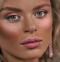 Face close-up. Woman, portrait. Pink blush, green eyes.