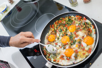 In the course of making breakfast with fresh eggs and vegetables