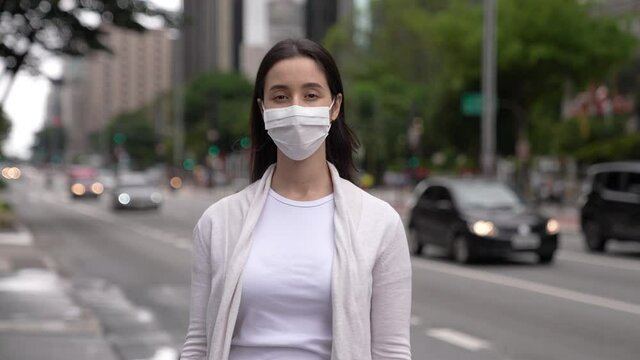 Portrait of beautiful white woman looking at camera looking confident. Paulista Avenue in Brazil. Urban city background. Real people series
