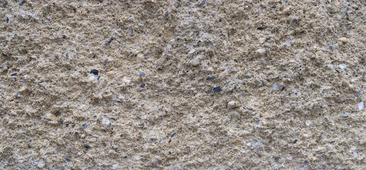 Textured plaster background. Old beige wall. Vintage effect. Textured background with pebbles. Copy space.