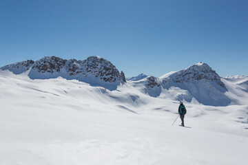 Fototapeta na wymiar women with snowshoes standing in snowy winter landscape in Schanfigg