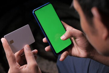 man hand holding credit card and using smart phone shopping online 