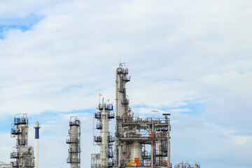 Industrial of oil refinery plant from industry zone ,Refinery factory oil storage tank and pipeline steel with blue sky.