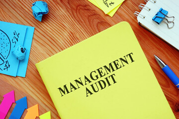 Management audit report and papers on the table.