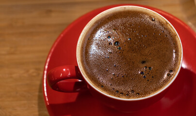 Black Coffee in the red cup close-up. Good morning concept.