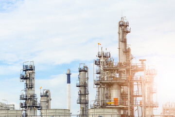 Industrial of oil refinery plant from industry zone ,Refinery factory oil storage tank and pipeline steel with blue sky.