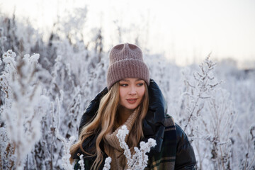 beautiful young woman in plaid blanket  smiles and laughs on a winter walk