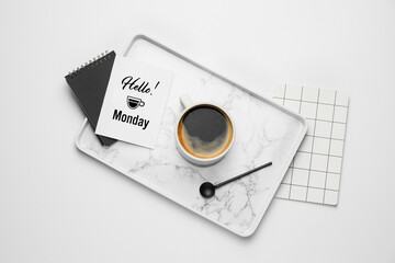 Composition with cup of coffee and greeting card with text HELLO MONDAY on white background