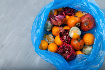 Unused fruits and vegetables. Rotten organic food waste in biodegradable plastic bag. Homemade compost