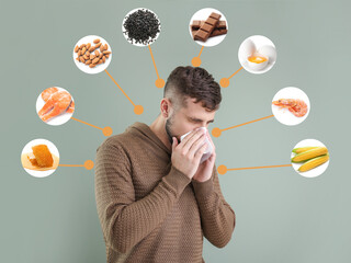 Young man suffering from food allergy on grey background