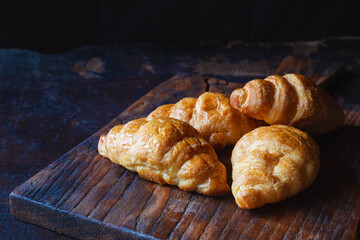 .Breakfast croissant bread on the wooden table