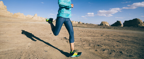 Fitness woman trail runner cross country running  on sand desert