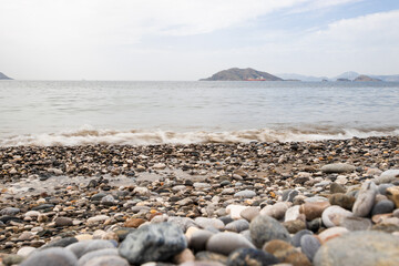 Fototapeta na wymiar summer pebble beach and raging sea