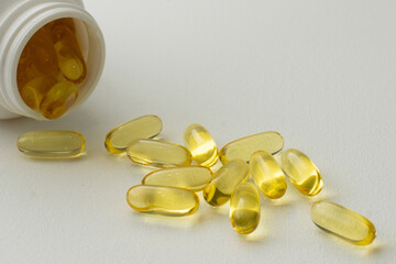 Two Soft Capsules in Palm omega 3 healthy diet concept