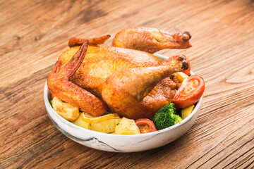roasted chicken and vegetables on wooden table