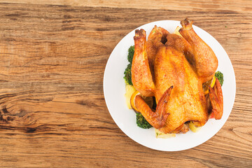 roasted chicken and vegetables on wooden table