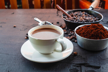 .Roasted coffee beans with coffee powder and coffee cups.