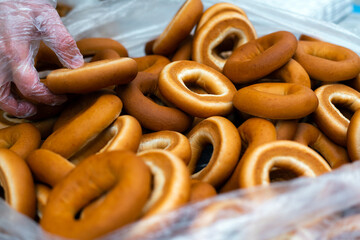 Close up of bagel buns at holiday fair. Bunch of sweet ring bun pastry for sale