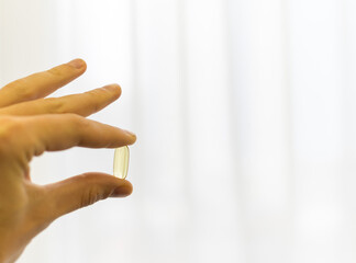 Holds Vitamin D Supplements omega 3 healthy diet concept