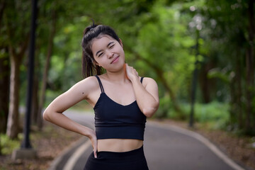 Fototapeta premium Asian woman is warm up, To make the muscles flexible Before going to jogging for good health and energy metabolism,Outdoors cross training workout. Healthcare concept