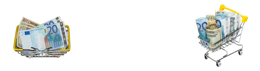 Dollar and euro bills mixed up in a shopping basket and rolled in a shopping cart. Isolated on white background. Banner size. Copy space in the middle. High angle view