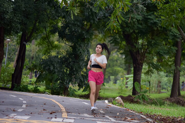 Asian woman is warm up, To make the muscles flexible Before going to jogging for good health and energy metabolism,Outdoors cross training workout. Healthcare concept
