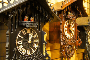 Close-up of two wooden, handcarved cuckoo clocks made in Germany.
