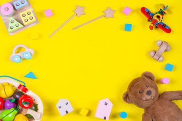 Baby kids toys frame on yellow background. Top view. Flat lay. Copy space for text