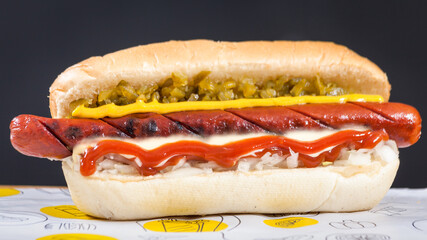 Sandwich with meat and vegetables on black bacground