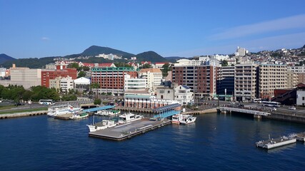 Cruise ship port in the downtown. Photo taken from the top deck of the leaving ship in Nagasaki, Japan 