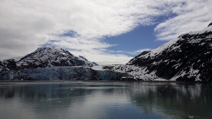 Margerie Glacier with surrounding mountains and the reflection in the sea in Glacier Bay national park