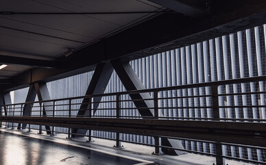 Interior of a modern multi-storey car park. Metal concrete structure.