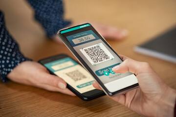 Woman scanning qr code for mobile payment