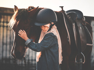 Asian Muslim school kid with horse.Retro vintage color tone of girl at horse ranch.Muslim  kid...