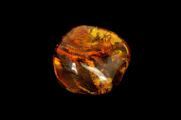 Baltic amber closeup on black background 