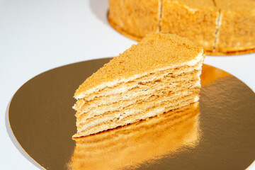 a piece of orange cake on a plate and cake on background